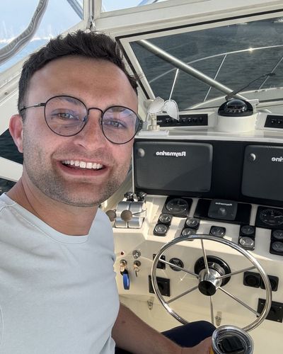Jake, owner of Farholm, at the helm of a boat on the water